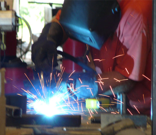 A VMI employee welding